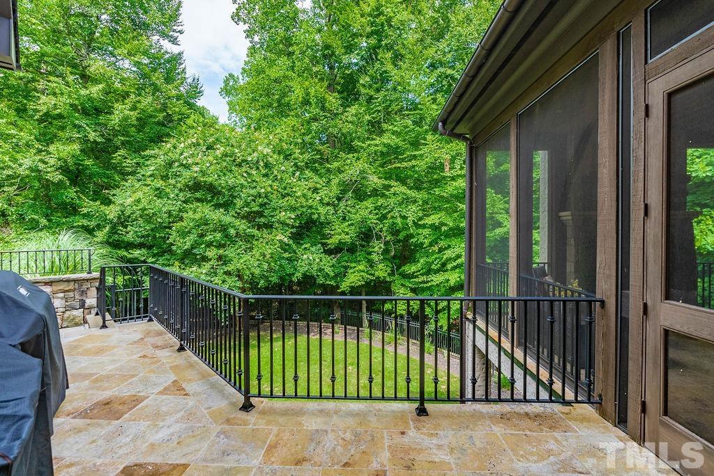 11213 Jonas Ridge Lane Raleigh, NC 27613 - Photo 98 of 100 a view of a house with a floor to ceiling window and wooden fence