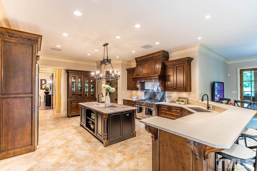 11213 Jonas Ridge Lane Raleigh, NC 27613 - Photo 10 of 100 a kitchen with stainless steel appliances a sink stove and refrigerator