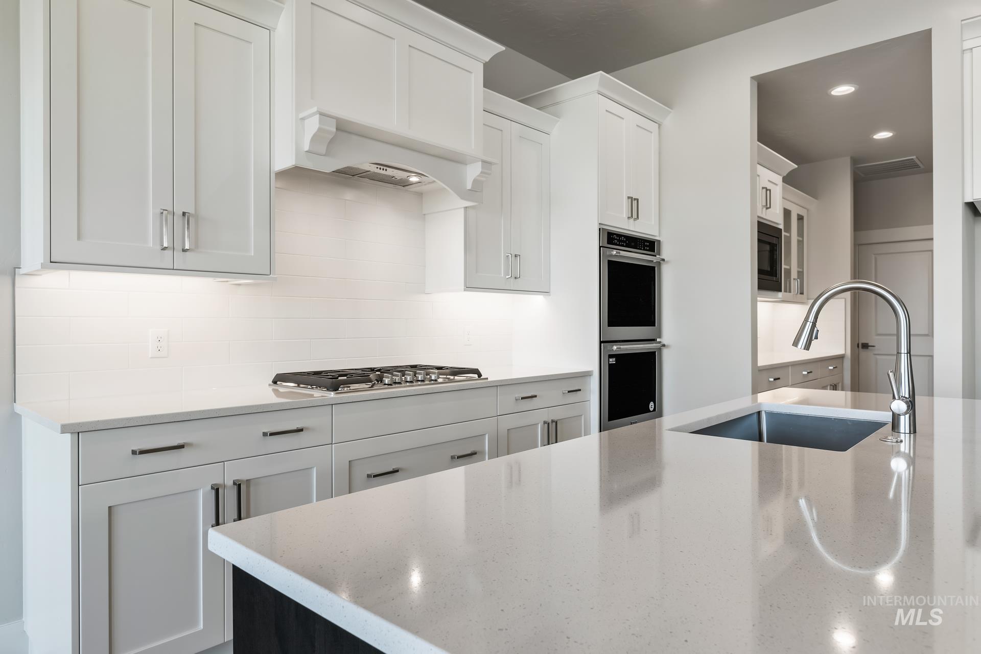 385 South Strut Way Boise, ID 83716 - Photo 19 of 30 Kitchen featuring light stone countertops, white cabinets, stainless steel appliances, and recessed lighting