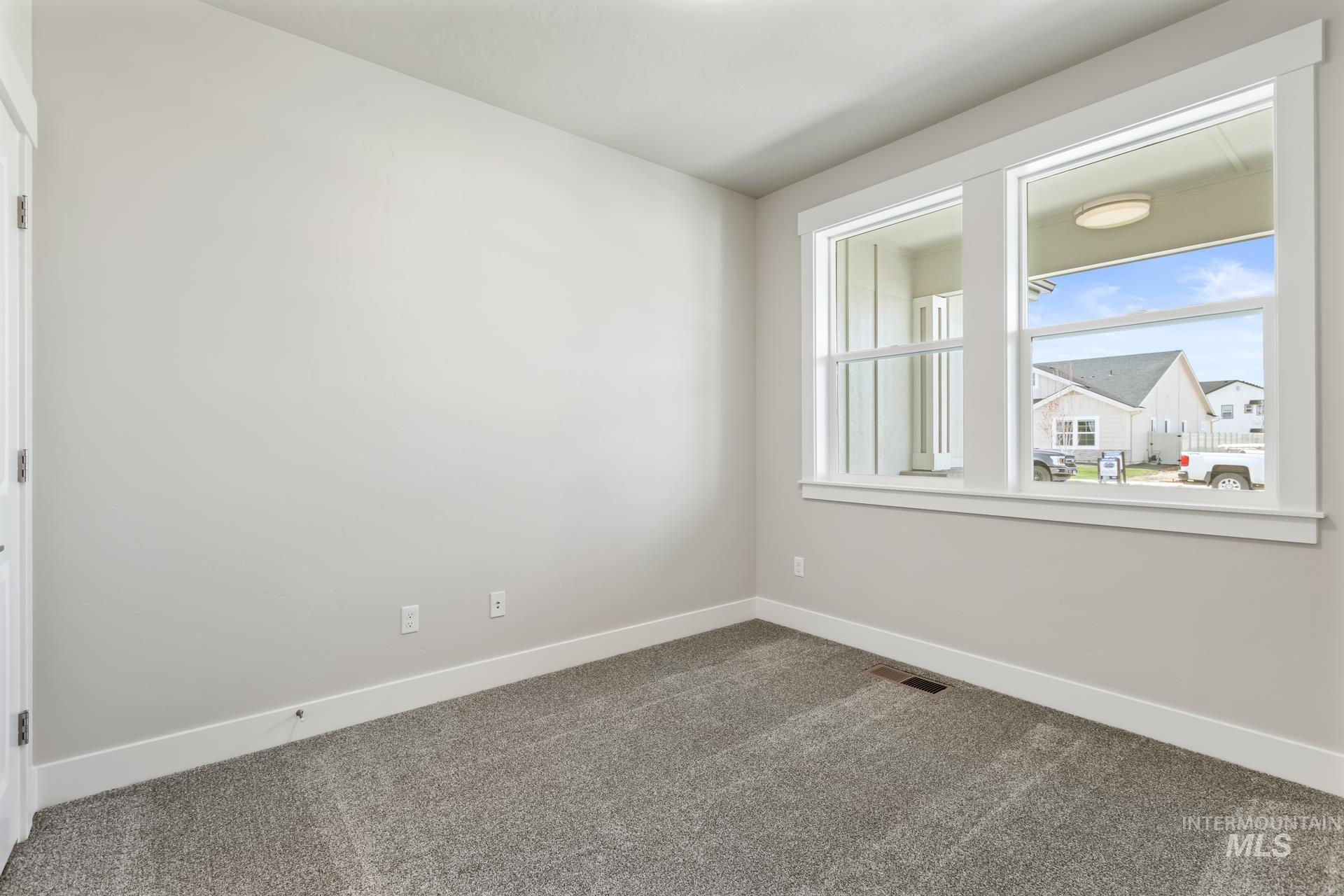 385 South Strut Way Boise, ID 83716 - Photo 8 of 30 Empty room with baseboards and dark carpet