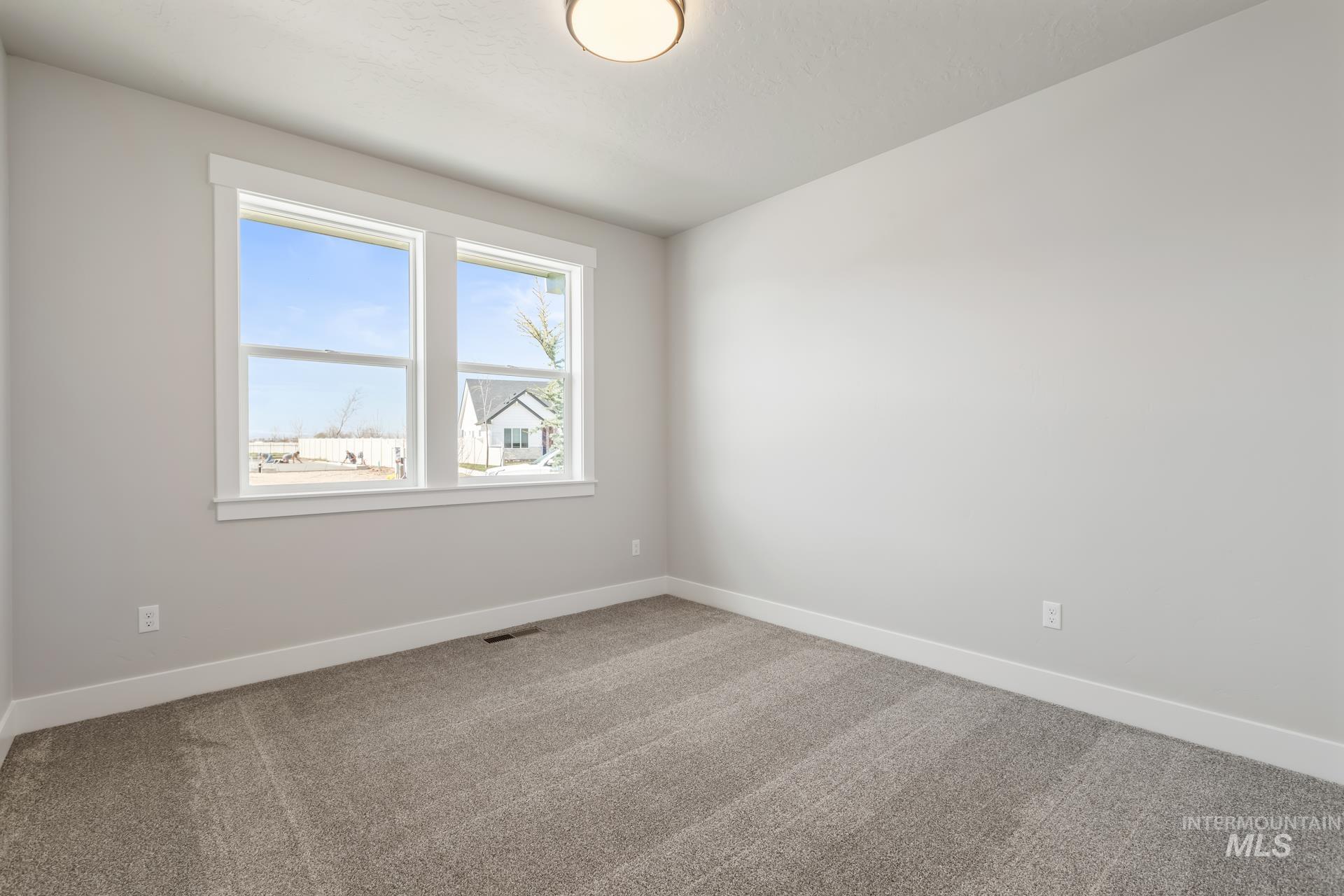 385 South Strut Way Boise, ID 83716 - Photo 9 of 30 Carpeted spare room featuring baseboards