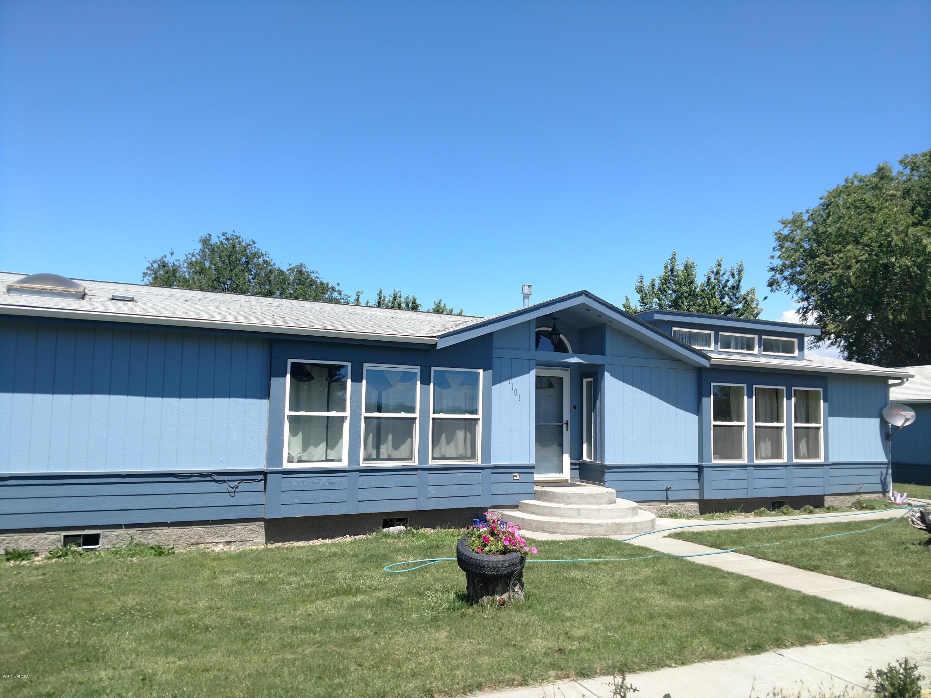 1101 Gap Road Granger, WA 98932 - Photo 2 of 24 a front view of a house with a garden