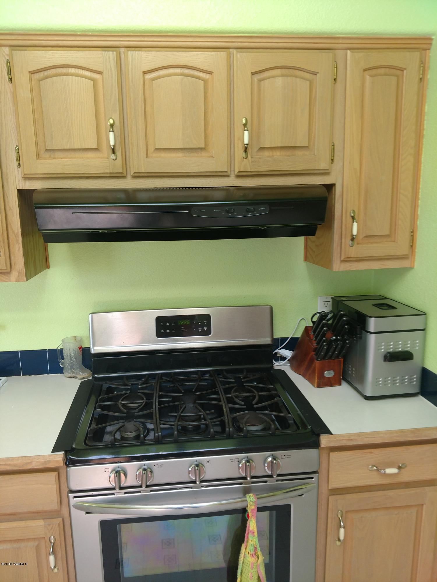 1101 Gap Road Granger, WA 98932 - Photo 15 of 24 a stove top oven sitting inside of a kitchen