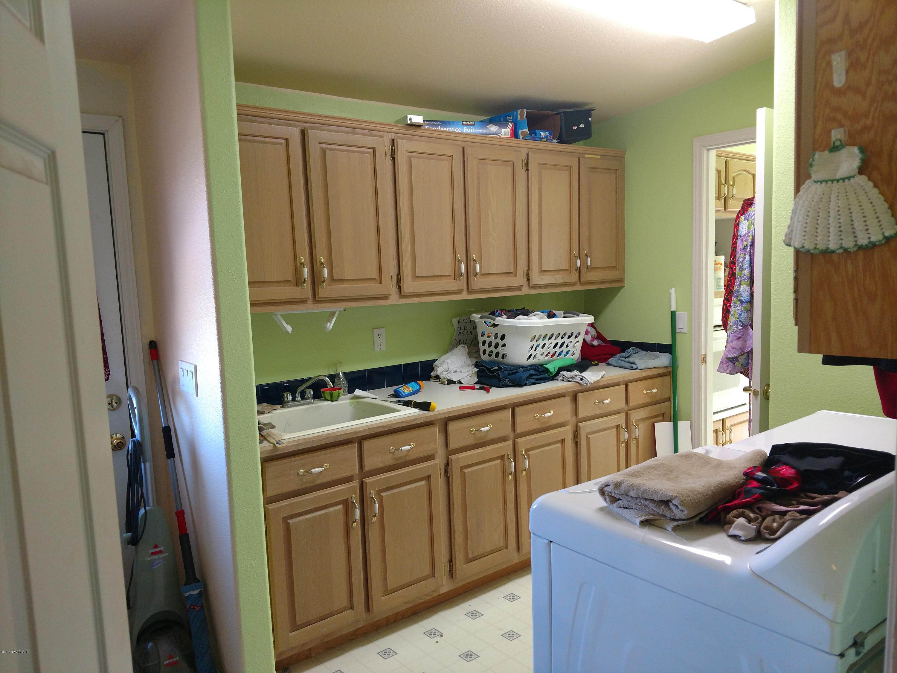 1101 Gap Road Granger, WA 98932 - Photo 16 of 24 a kitchen with a sink cabinets and utility