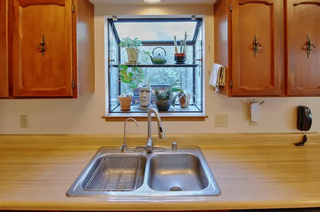 a kitchen with stainless steel appliances granite countertop a sink stove and cabinets