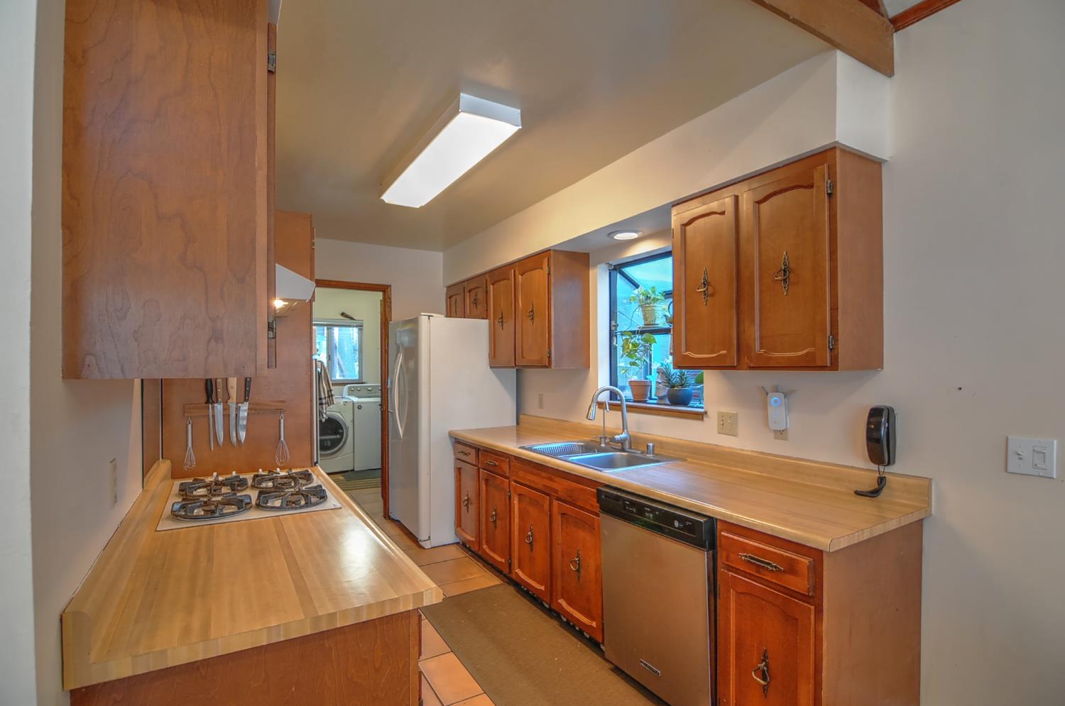 16914 Pasquale Road Nevada City, CA 95959 - Photo 19 of 32 a kitchen with stainless steel appliances granite countertop a sink stove and cabinets