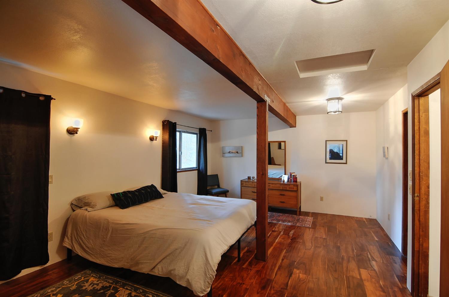 16914 Pasquale Road Nevada City, CA 95959 - Photo 22 of 32 a bedroom with a bed and dresser with mirror