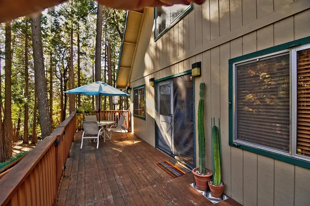 a balcony with table and chairs