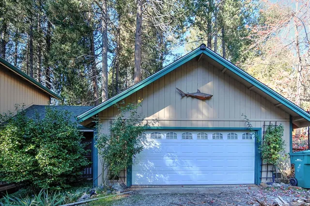 a black and white building with trees in the background