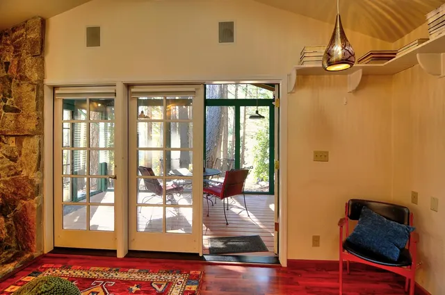 a room with wooden floor and windows