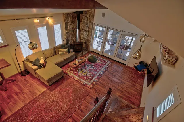 a living room with furniture and a floor to ceiling window