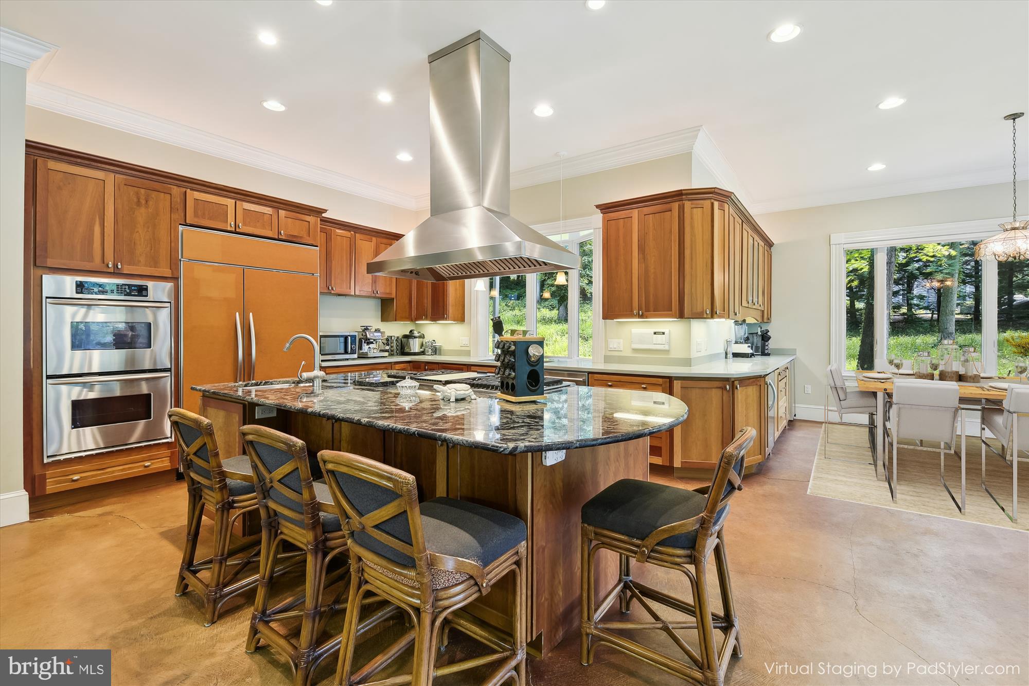 357 Forest Beach Road Annapolis, MD 21409 - Photo 11 of 91 a kitchen with stainless steel appliances kitchen island granite countertop a table chairs and a refrigerator