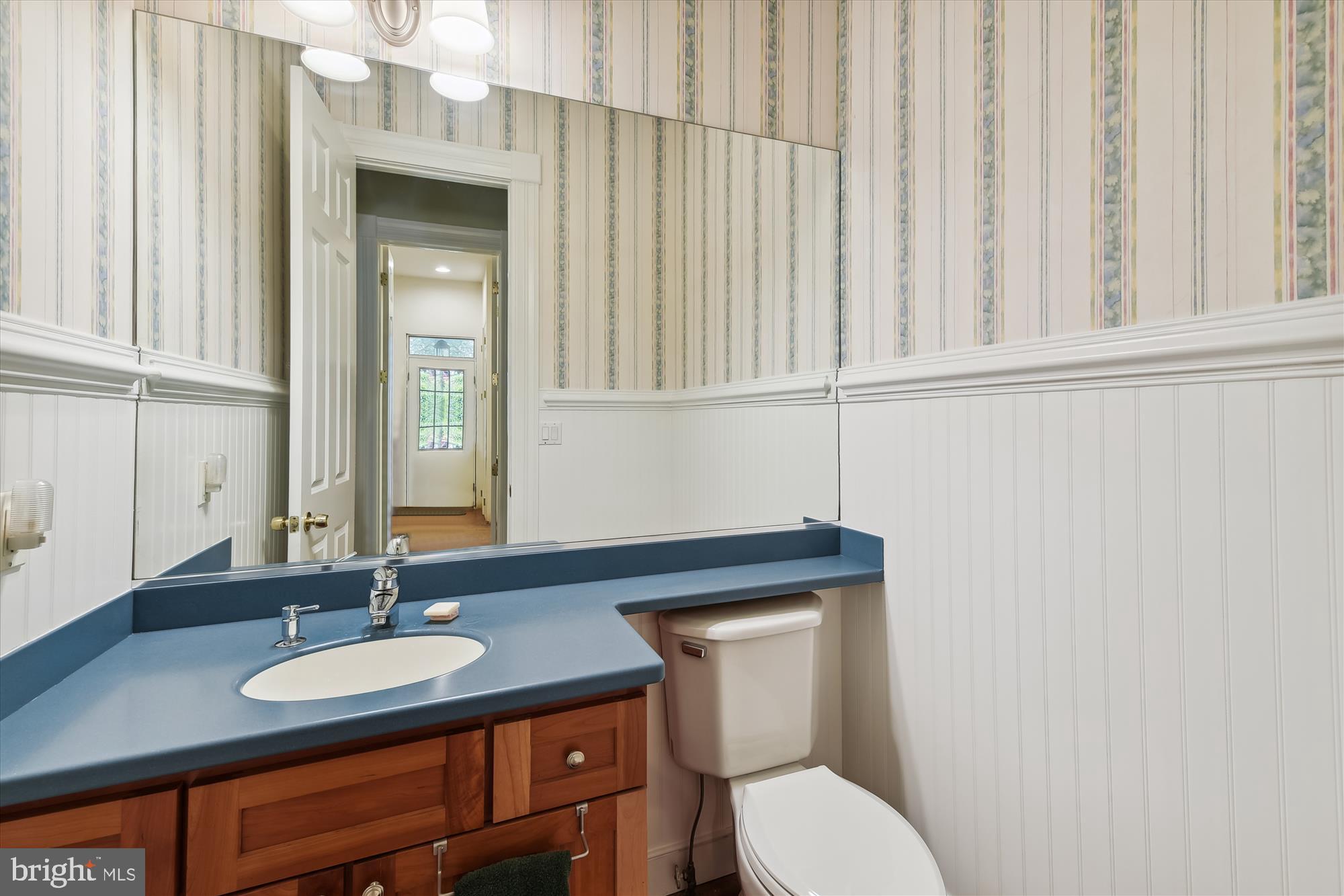 357 Forest Beach Road Annapolis, MD 21409 - Photo 21 of 91 a bathroom with a toilet a sink and mirror