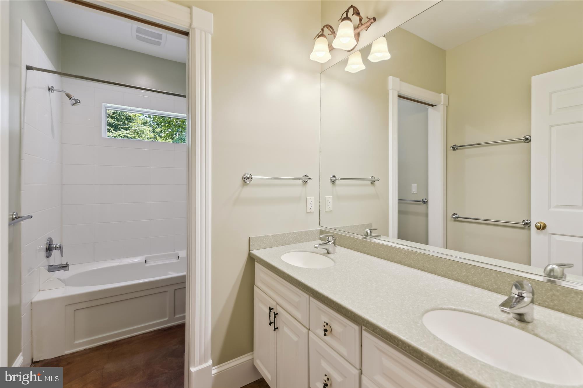 357 Forest Beach Road Annapolis, MD 21409 - Photo 28 of 91 a bathroom with a granite countertop sink a large mirror and a bathtub