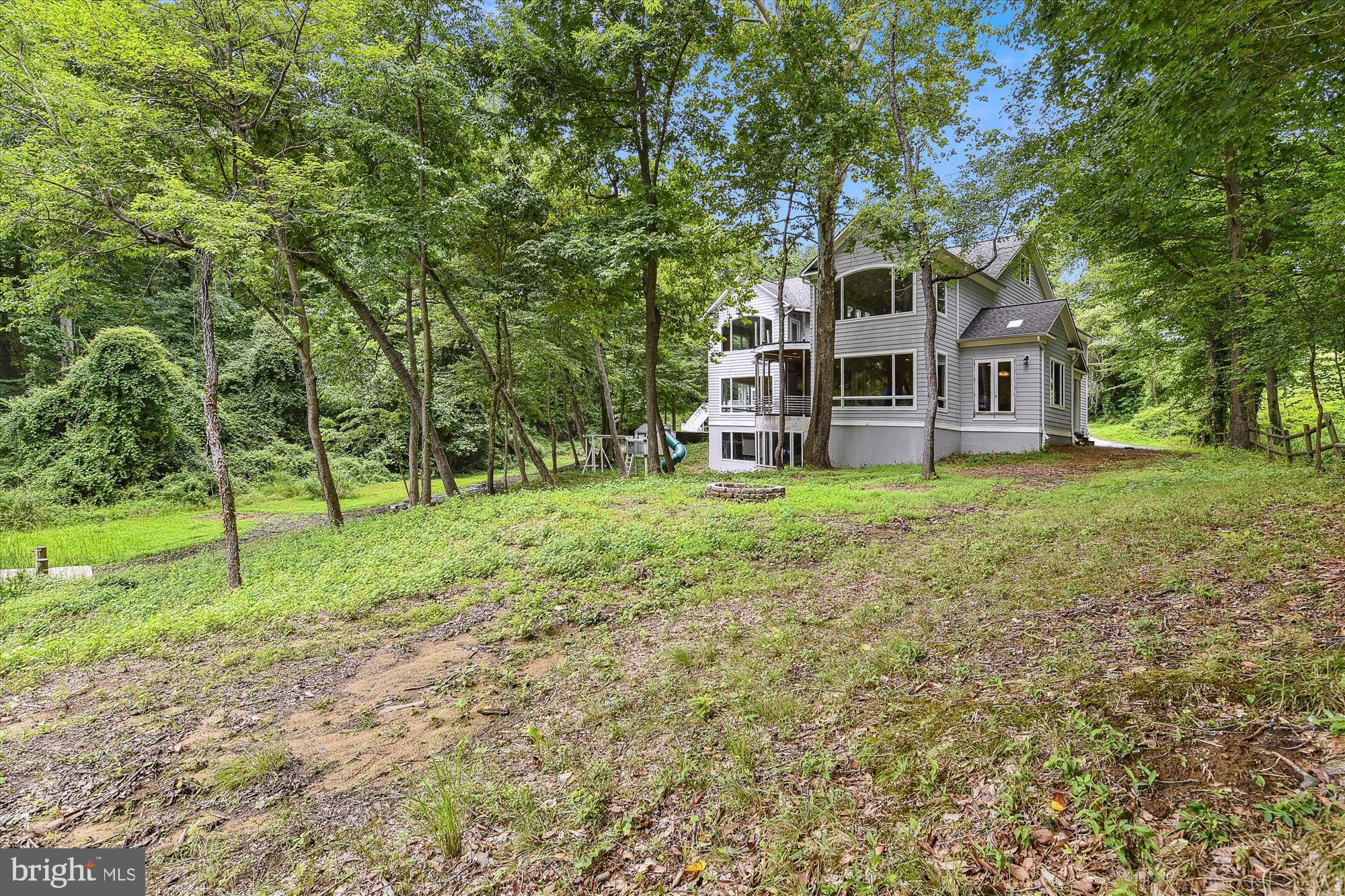 357 Forest Beach Road Annapolis, MD 21409 - Photo 57 of 91 a view of a house with a big yard and large trees