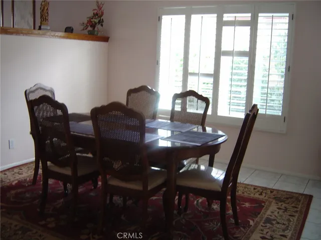 a view of a dining room with furniture and window