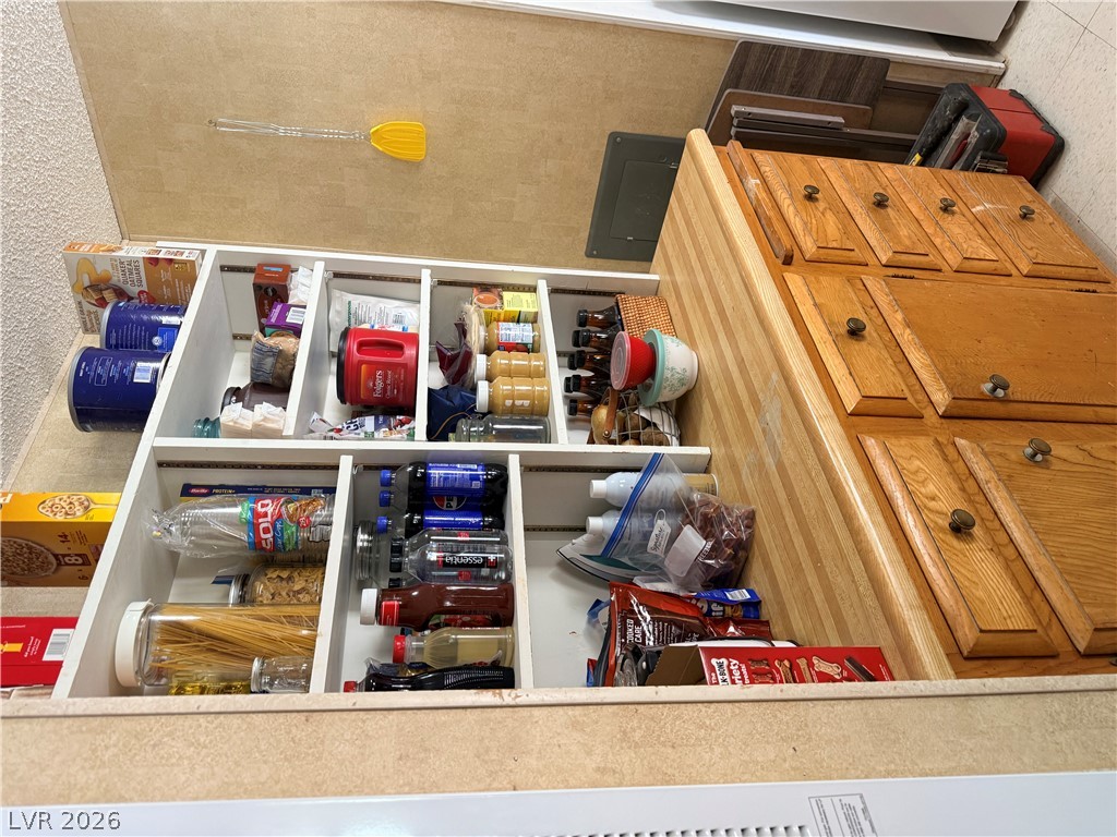1391 West Dyer Road Pahrump, NV 89048 - Photo 43 of 50 Smartly organized pantry with custom shelving optimizes storage for kitchen essentials.