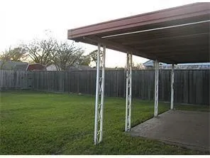 a view of a backyard with wooden fence