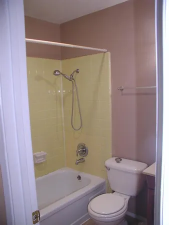 a bathroom with a toilet and a shower