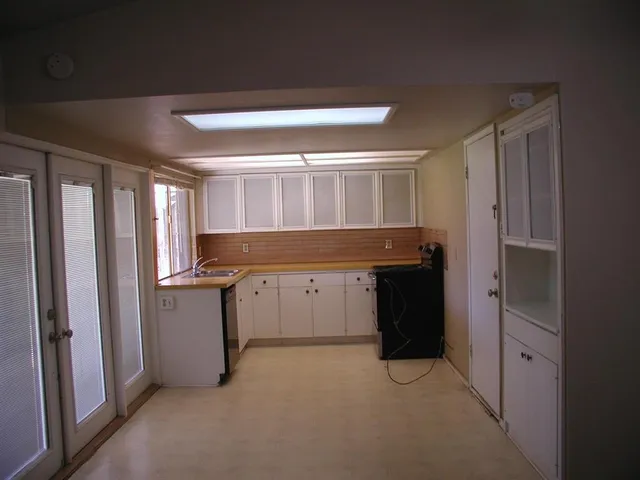 a kitchen with a refrigerator and window