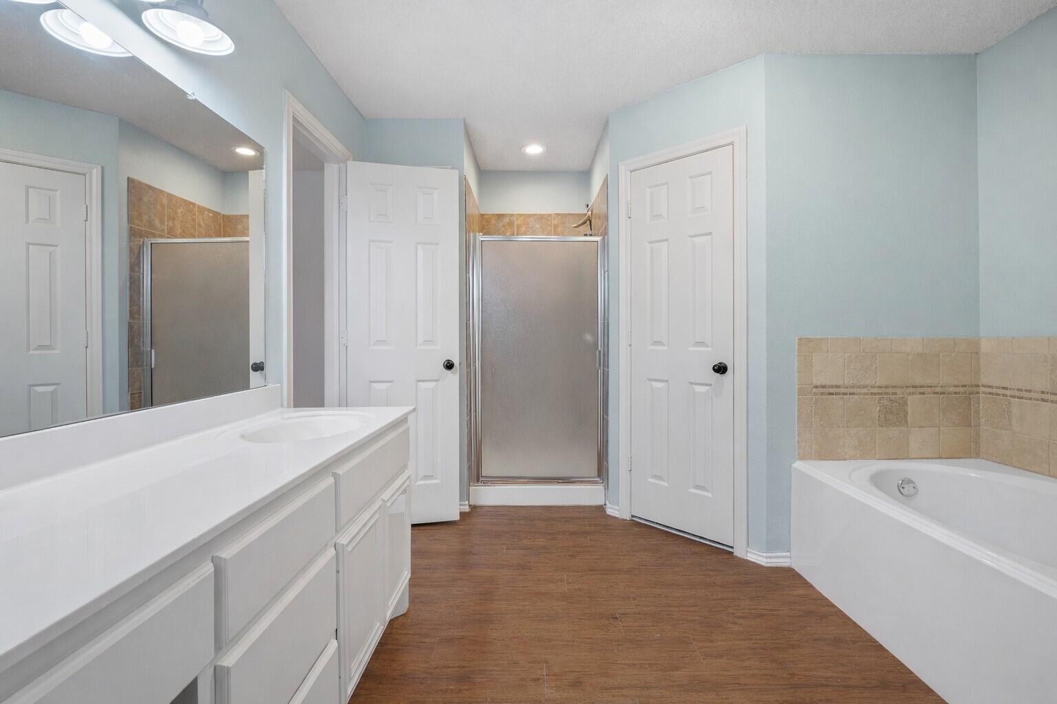 6115 100th Street Lubbock, TX 79424 - Photo 17 of 27 a bathroom with a bathtub and a sink