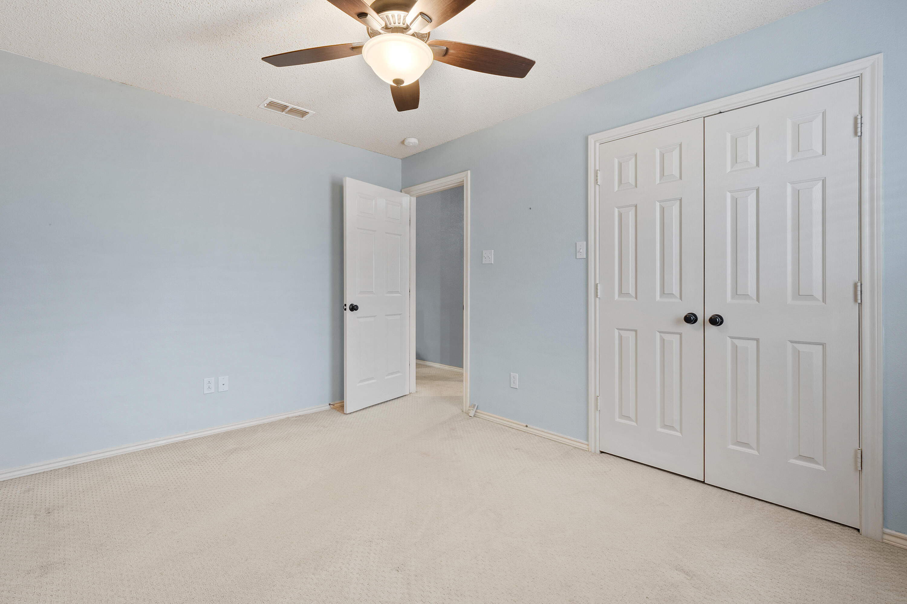6115 100th Street Lubbock, TX 79424 - Photo 18 of 27 an empty room with chandelier fan