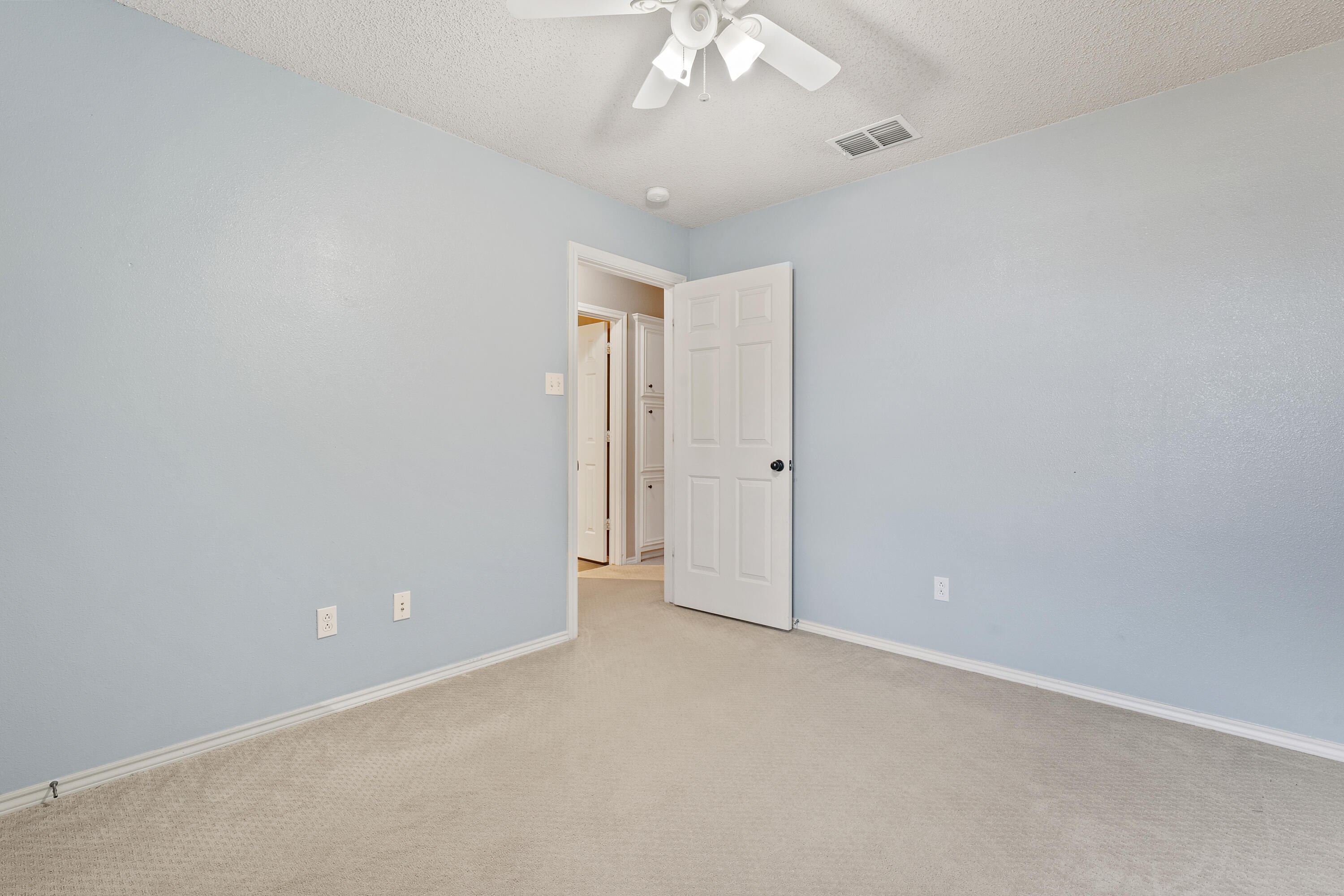 6115 100th Street Lubbock, TX 79424 - Photo 22 of 27 an empty room with a empty space and a ceiling fan