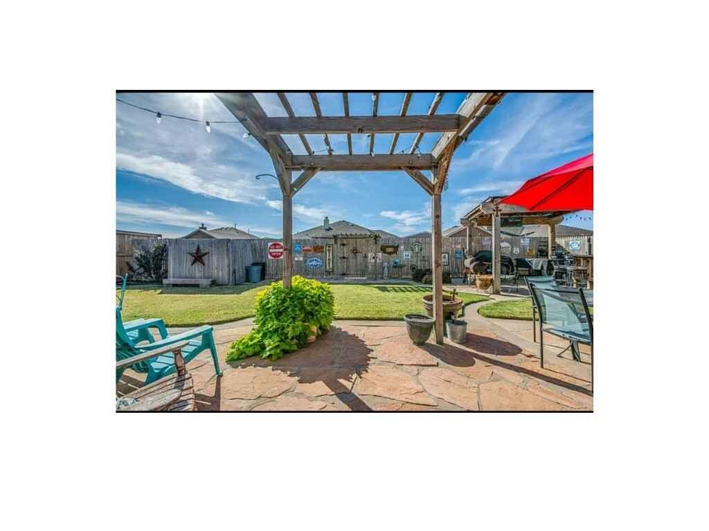 6115 100th Street Lubbock, TX 79424 - Photo 3 of 27 a view of a bench in the backyard