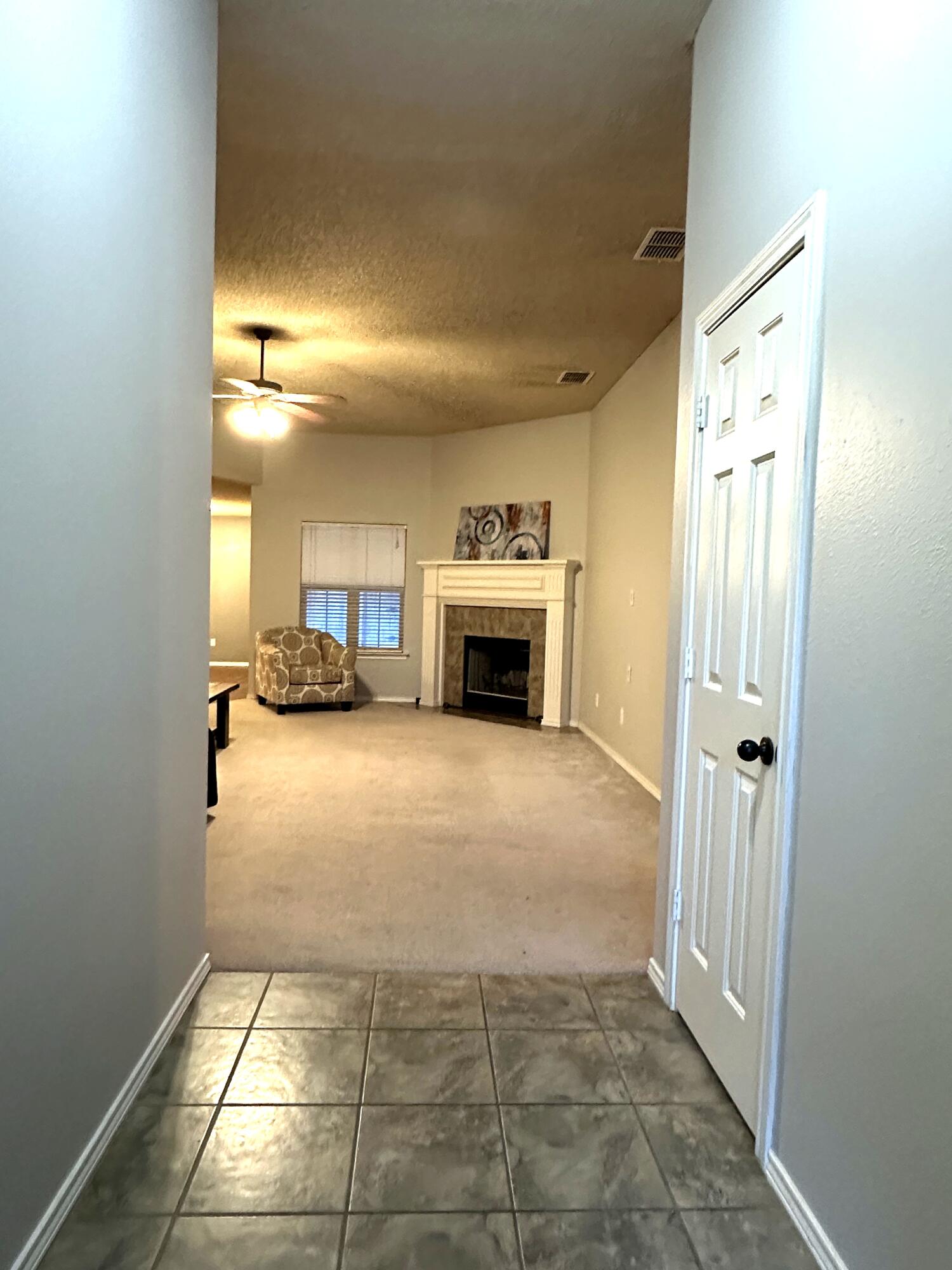 6115 100th Street Lubbock, TX 79424 - Photo 5 of 27 a view of a livingroom with a fireplace and a window