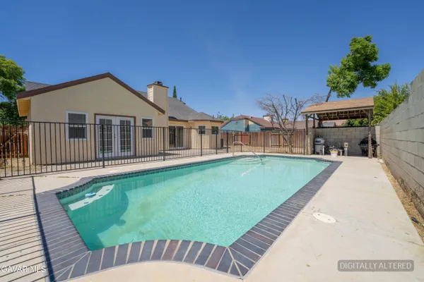 a view of a house with a backyard