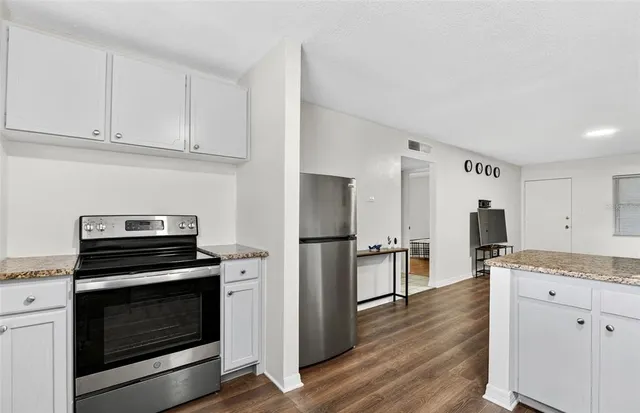 a kitchen with a stove and a refrigerator