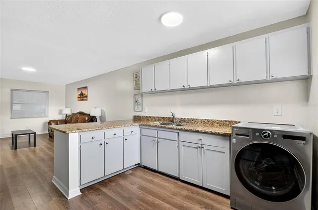 a kitchen with cabinets stove top oven and cabinets