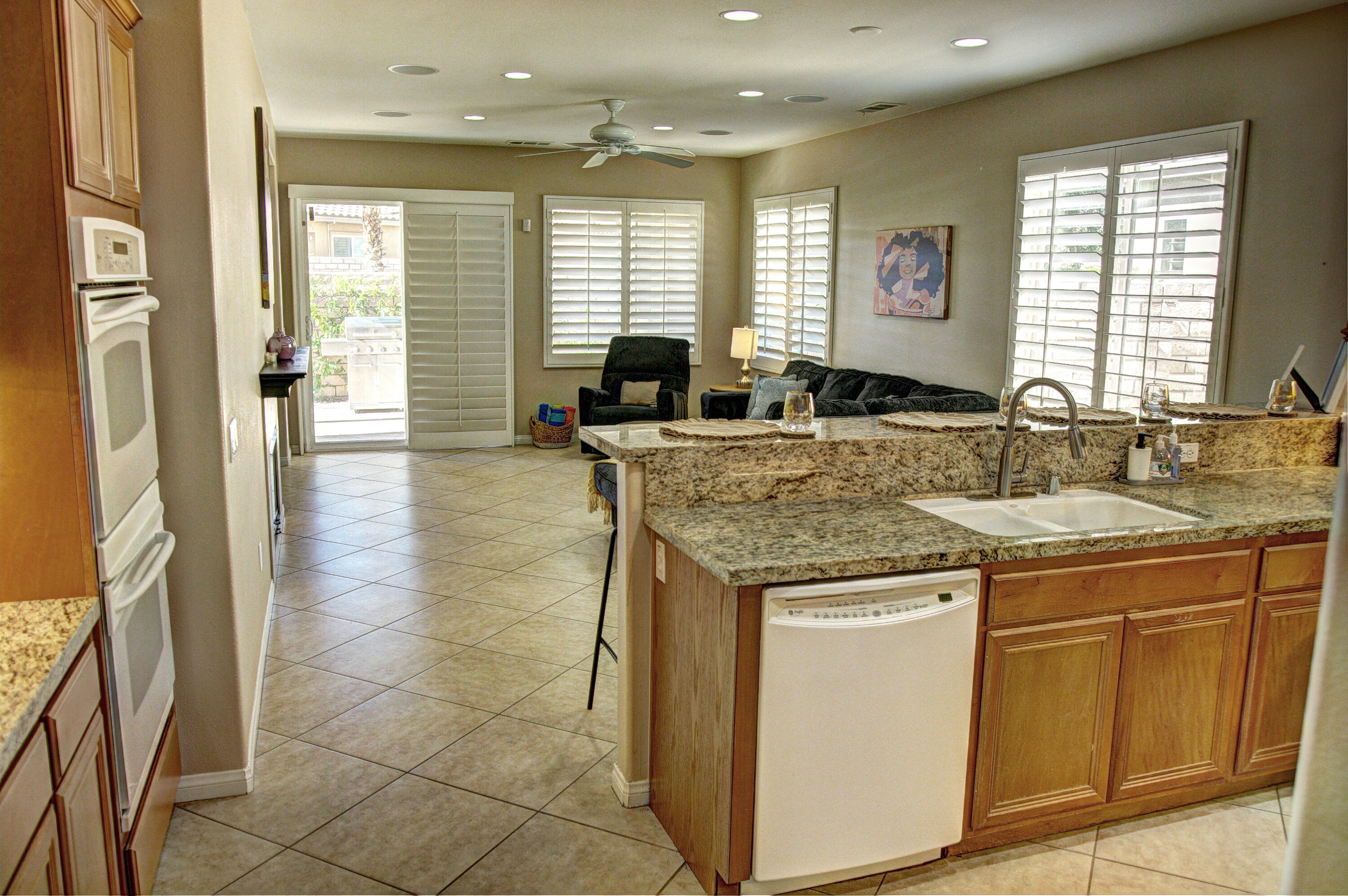 82053 Cochran Drive Indio, CA 92201 - Photo 11 of 38 a kitchen with a sink stove and cabinets