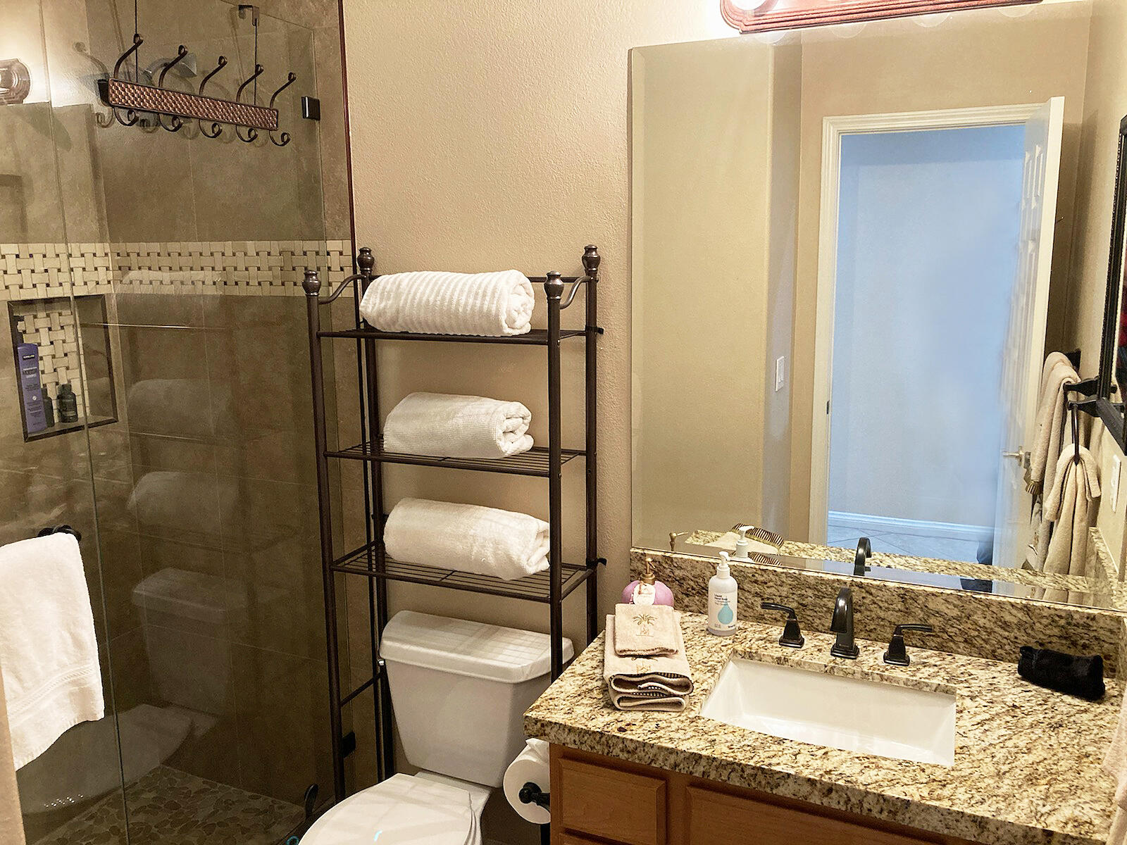 82053 Cochran Drive Indio, CA 92201 - Photo 19 of 38 a bathroom with a granite countertop sink mirror vanity and toilet
