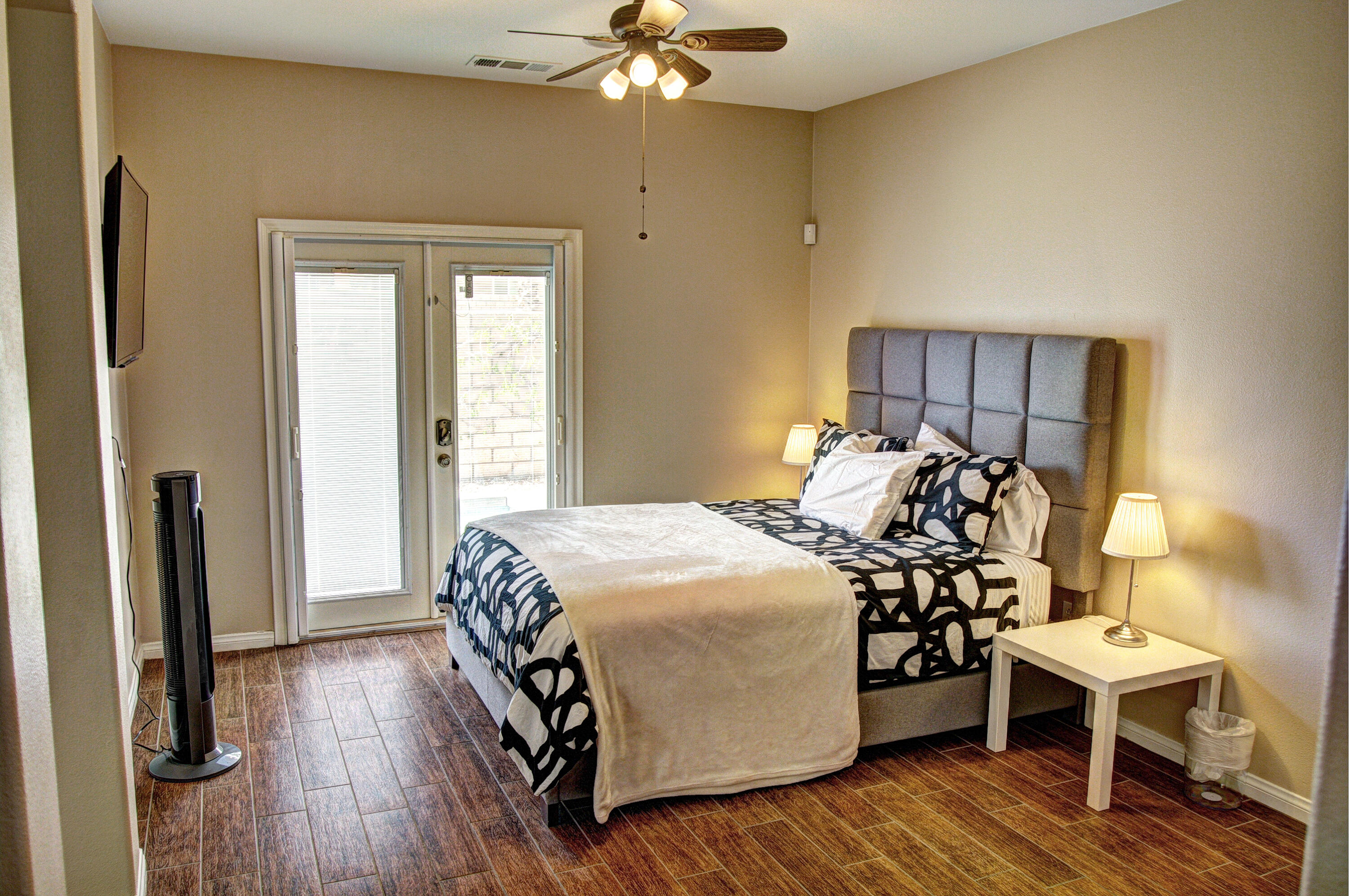 82053 Cochran Drive Indio, CA 92201 - Photo 22 of 38 a bedroom with a bed and a chandelier