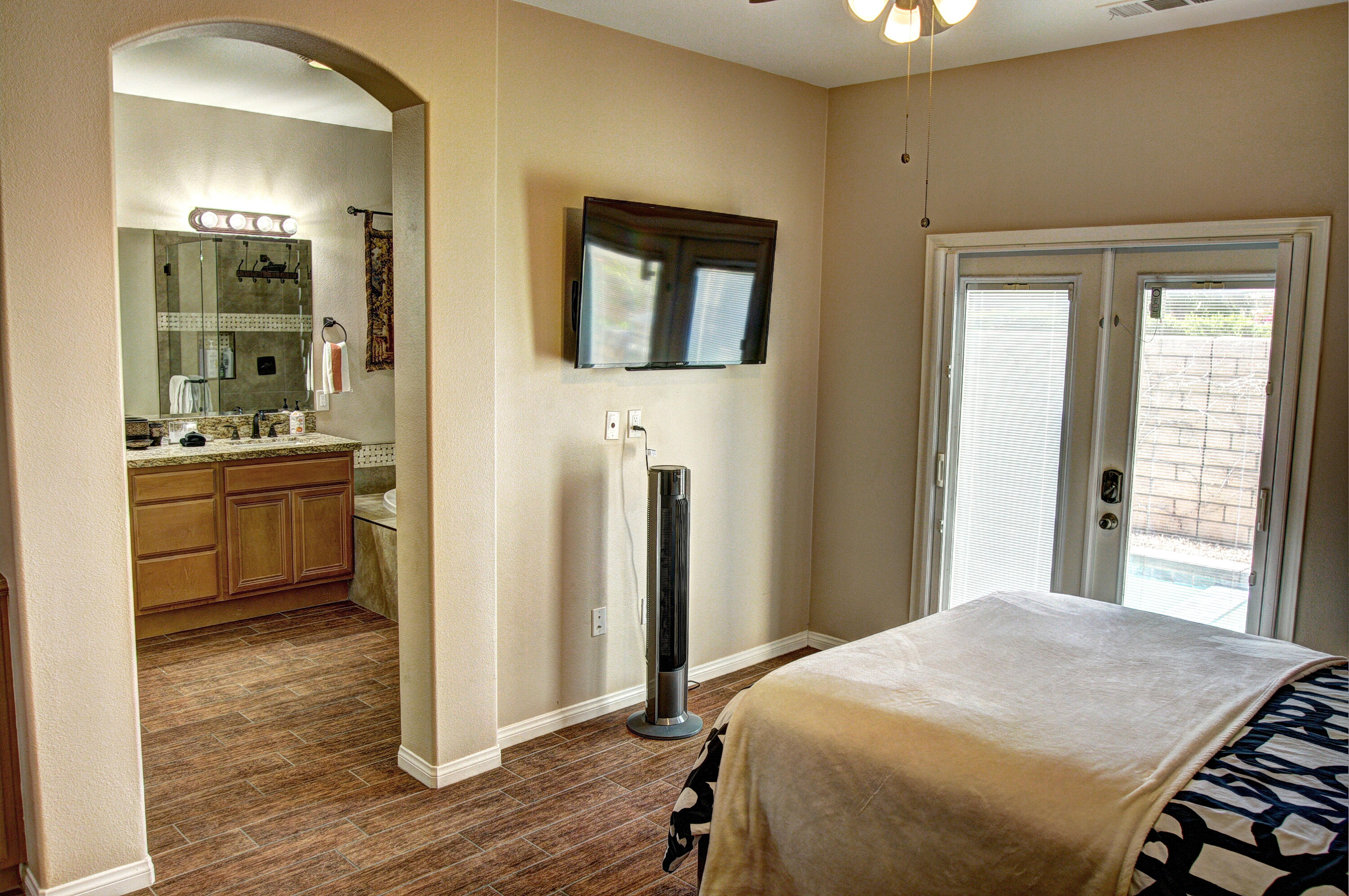82053 Cochran Drive Indio, CA 92201 - Photo 23 of 38 a bedroom with a bed and a view of bathroom