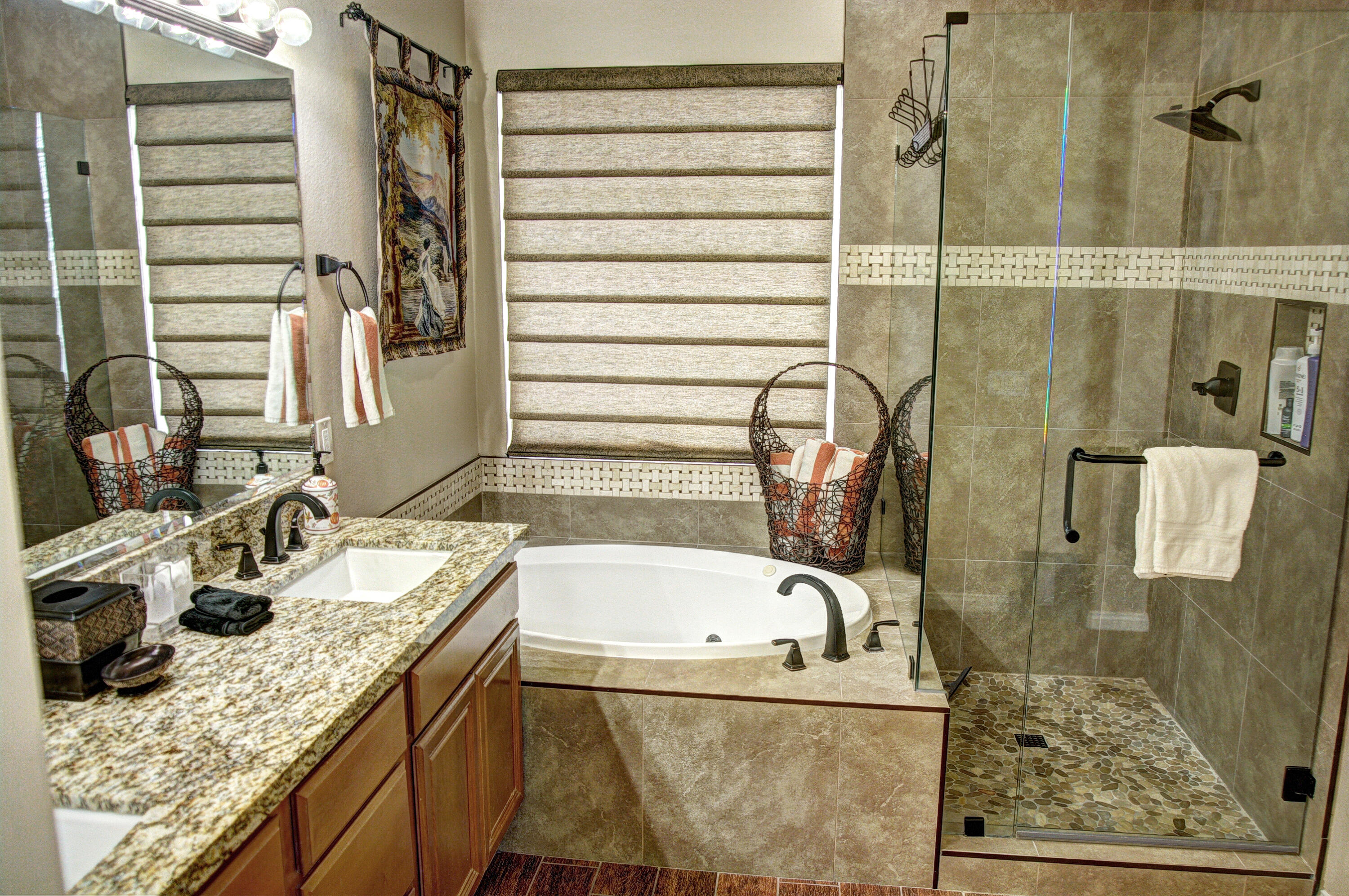 82053 Cochran Drive Indio, CA 92201 - Photo 26 of 38 a bathroom with a granite countertop bathtub and a shower
