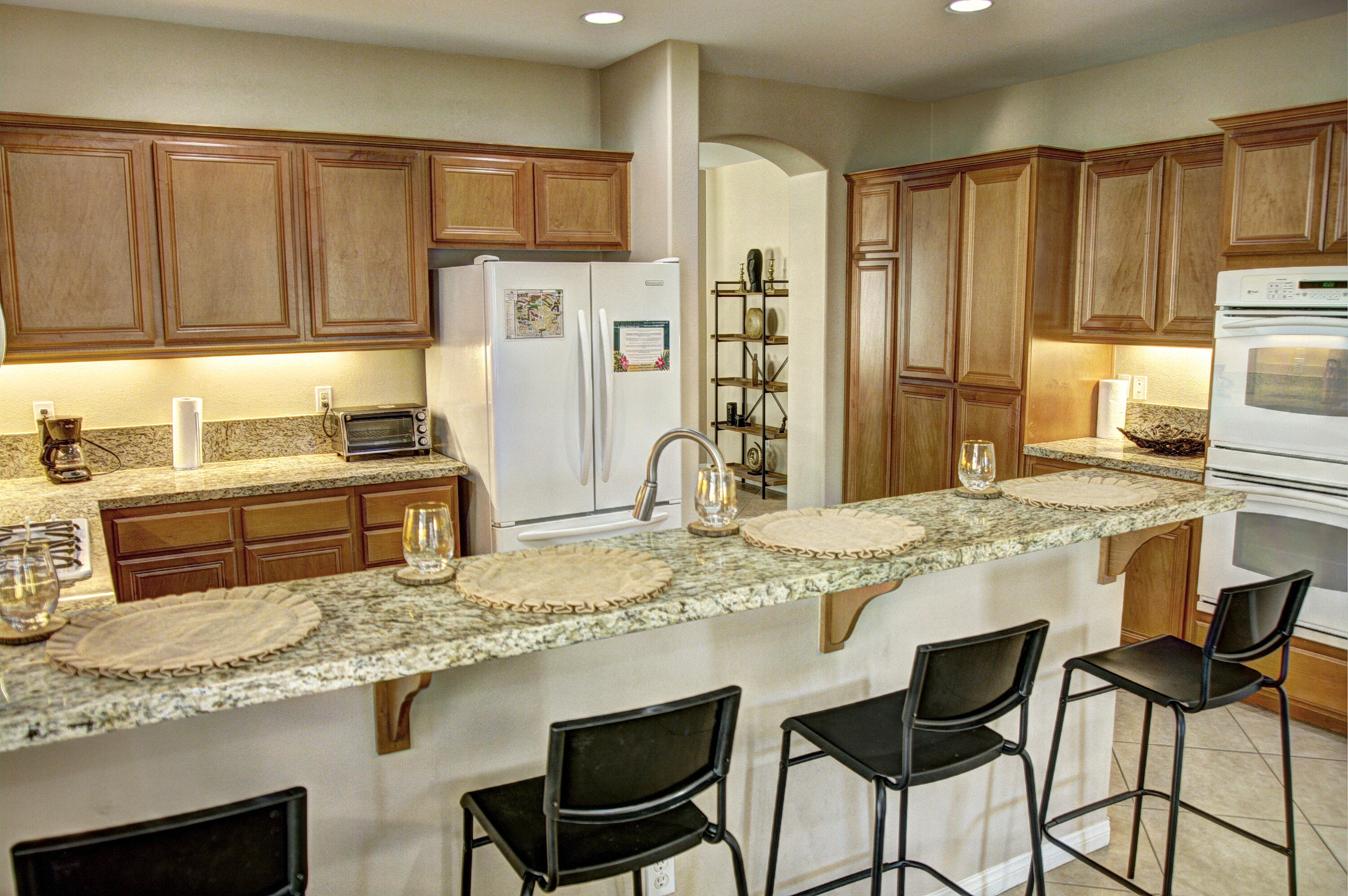 82053 Cochran Drive Indio, CA 92201 - Photo 7 of 38 a kitchen with granite countertop a sink stove and refrigerator
