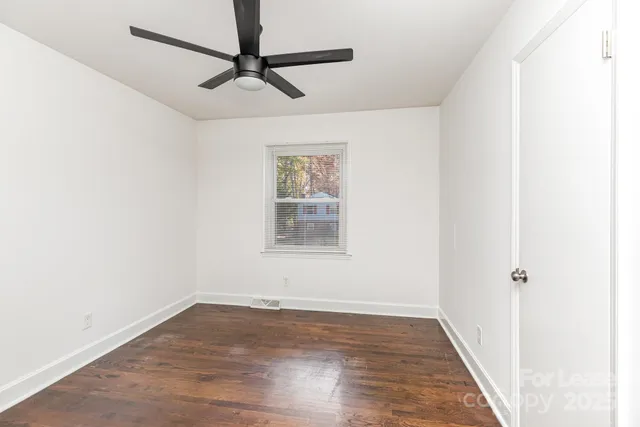 a view of a room with wooden floor closet and windows