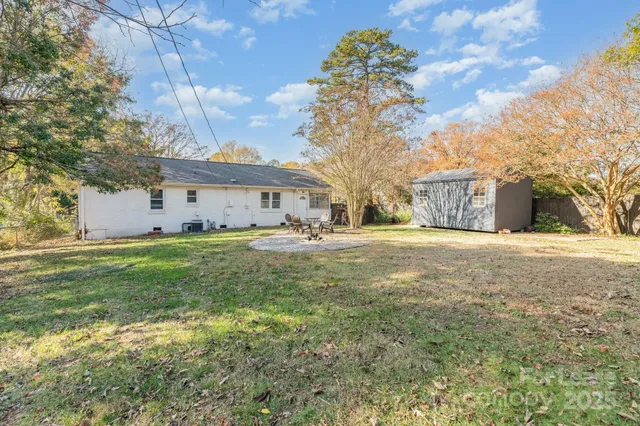 a view of an house with backyard space and balcony