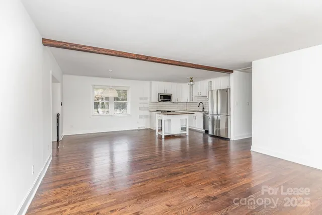 a view of kitchen with furniture and wooden floor
