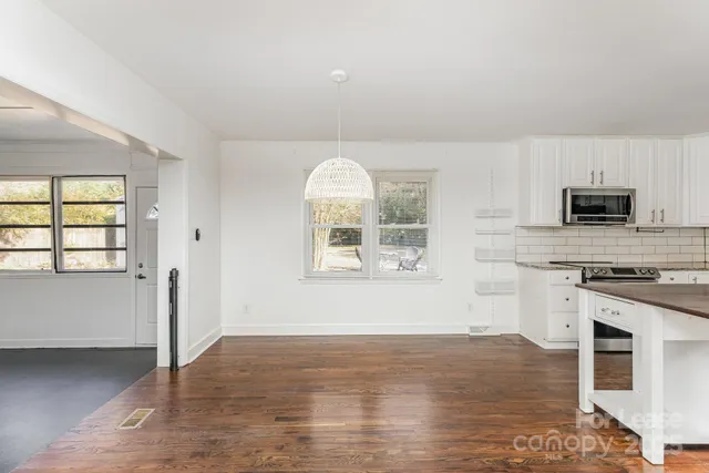 a kitchen with a stove a sink and a microwave