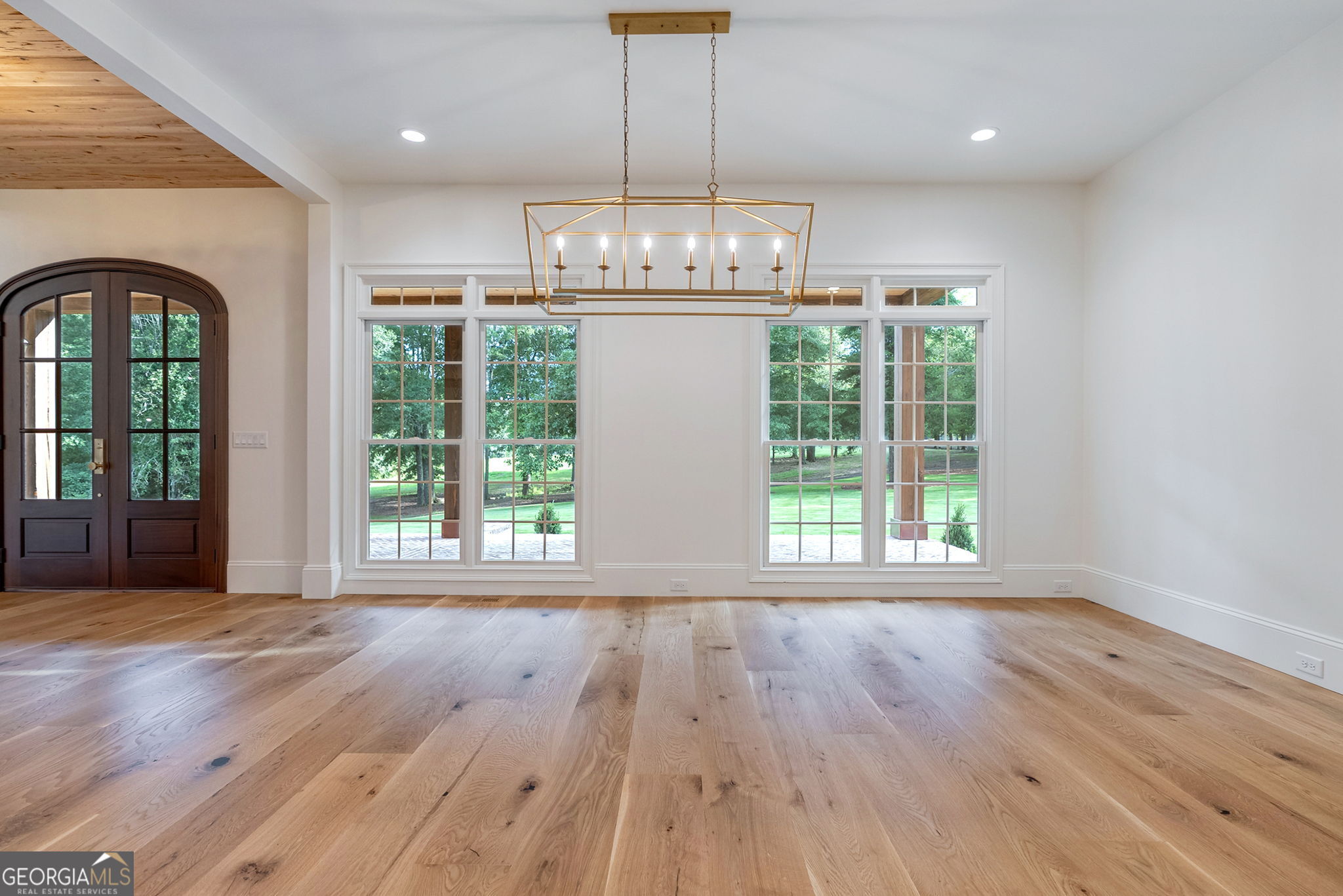 1321 Garrett Road Statham, GA 30666 - Photo 29 of 161 a view of an empty room with wooden floor and a window