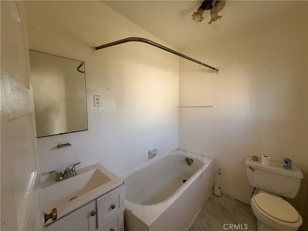 2035 North Grandee Avenue Compton, CA 90222 - Photo 14 of 21 a bathroom with a sink a toilet and shower