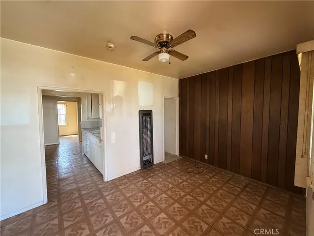 a view of a livingroom with a ceiling fan and window