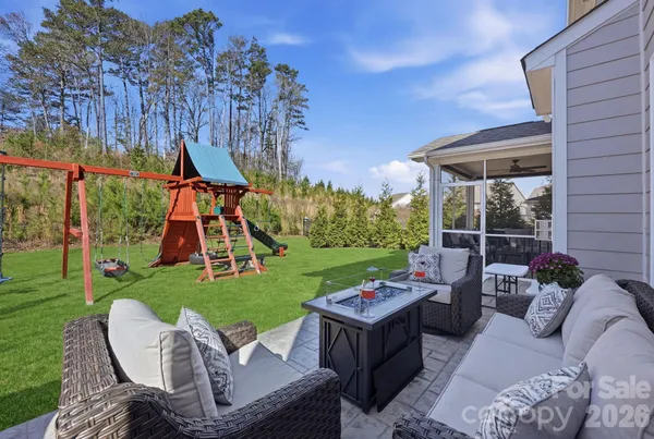 a view of a patio with couches chairs and a yard