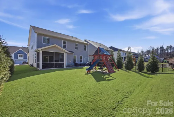 a view of a house with a yard and sitting area