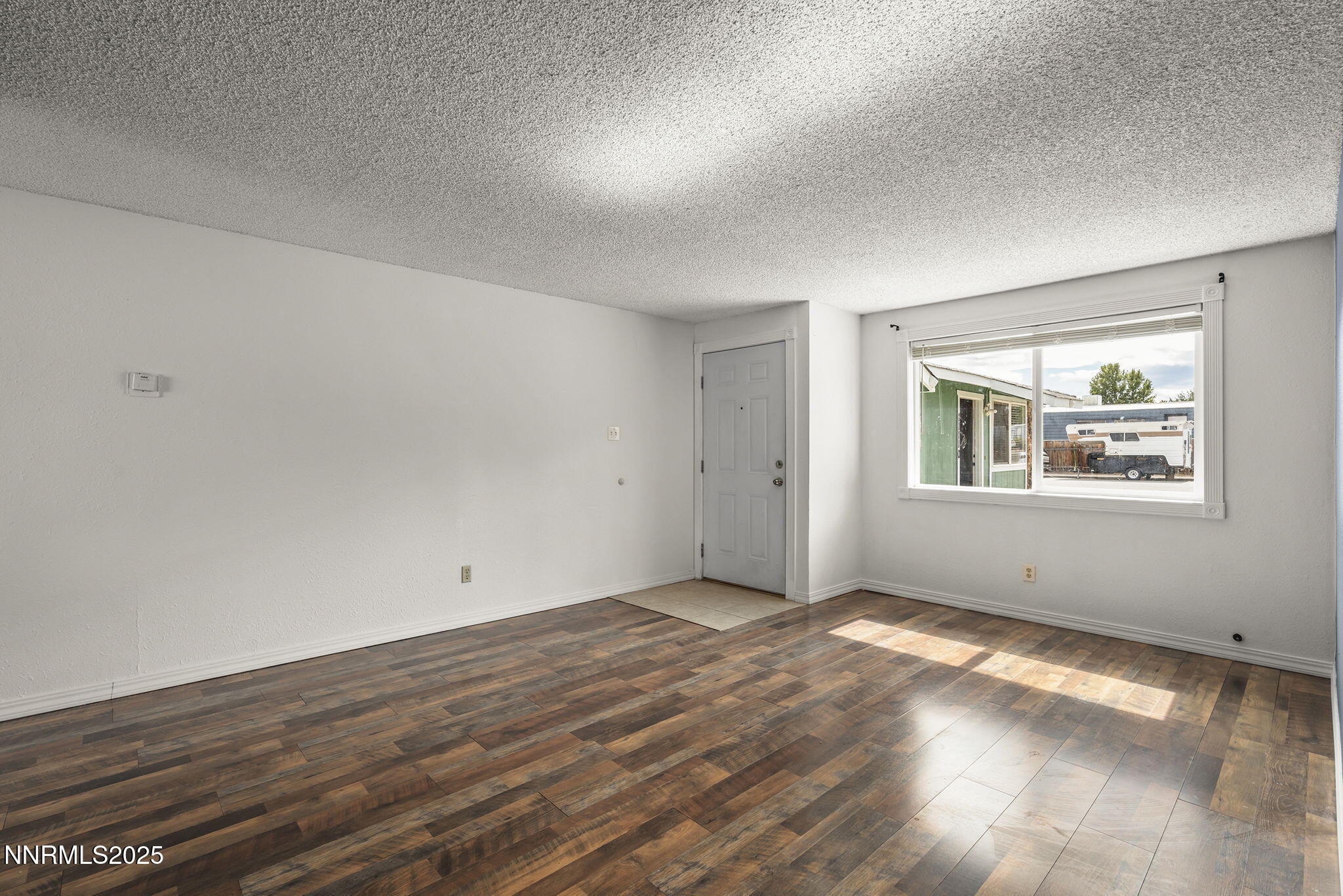 10005 Sagewood Drive Reno, NV 89506 - Photo 11 of 43 an empty room with wooden floor and windows