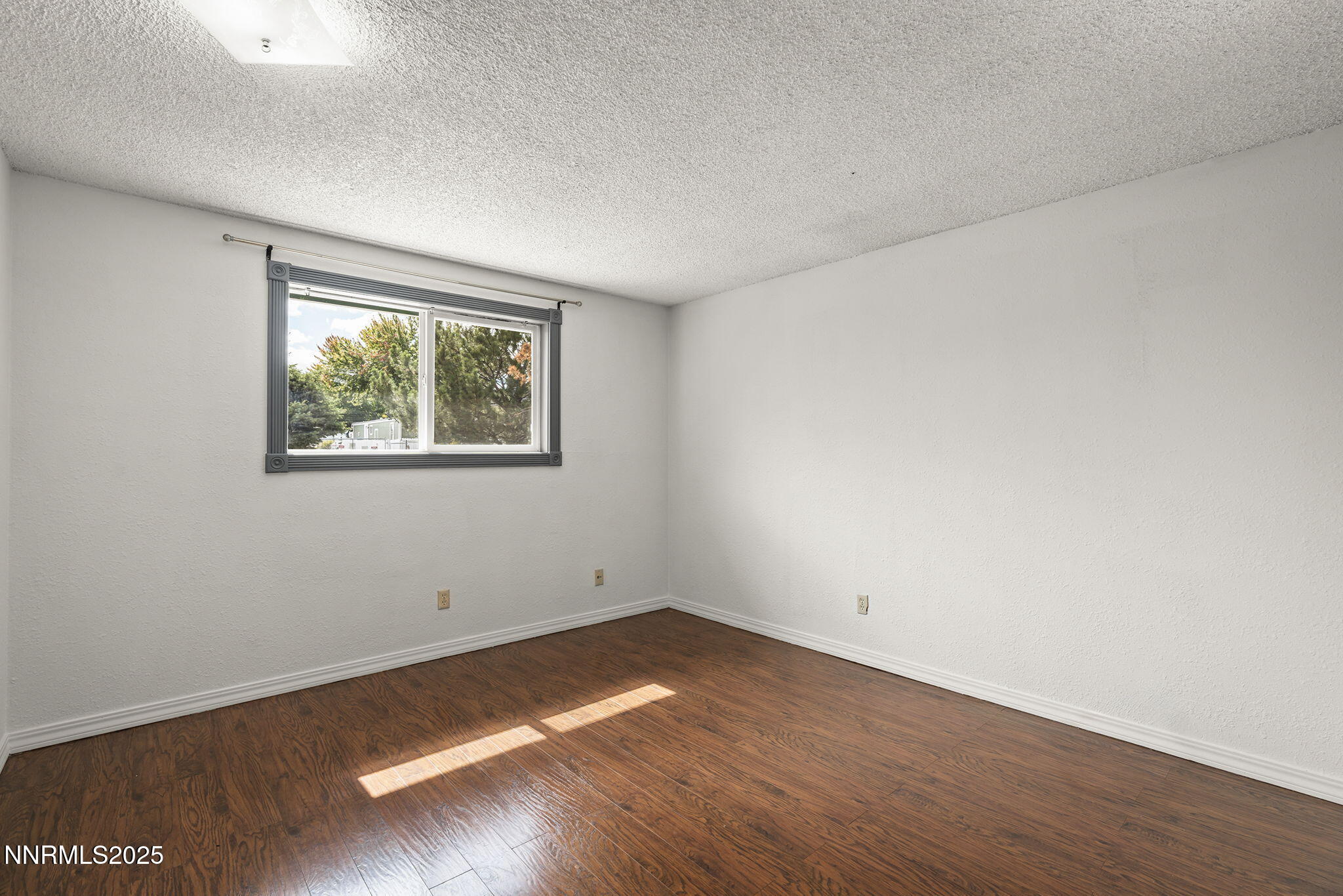 10005 Sagewood Drive Reno, NV 89506 - Photo 13 of 43 an empty room with wooden floor and windows