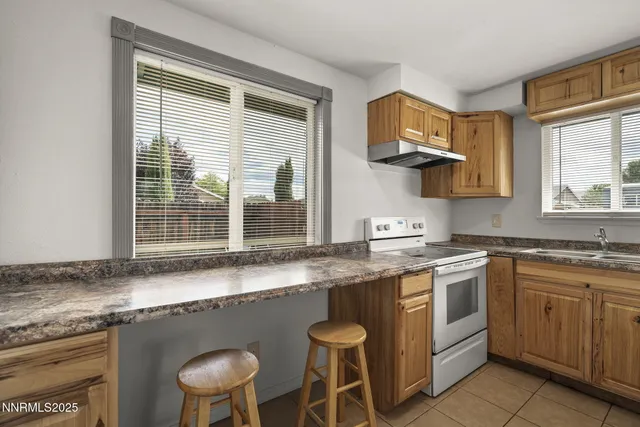 a kitchen with a sink cabinets and window